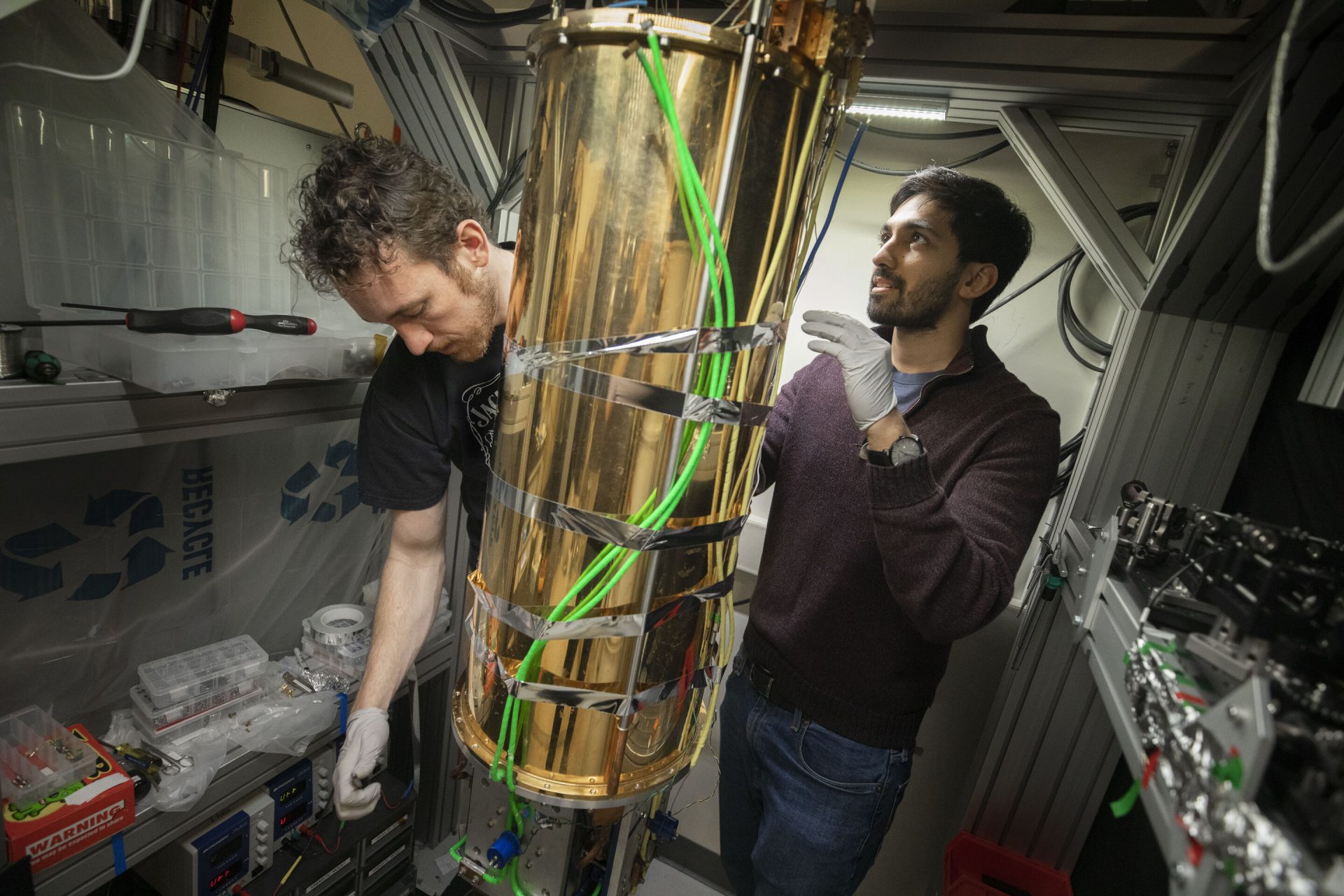 Mikhail Lukin, The George Vasmer Leverett Professor of Physics (not pictured) and GSAS students, David Levonian, (left) and Mihir Bhaskar are Harvard researchers who have built the missing link for an ultra-secure quantum internet inside LISE. Credit: Kris Snibbe/Harvard Staff Photographer